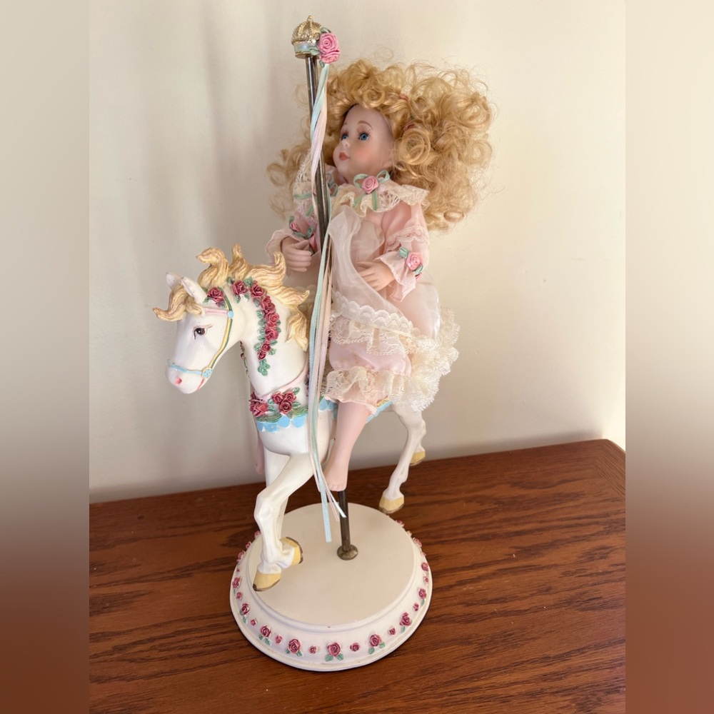 Porcelain doll on porcelain carousel horse
